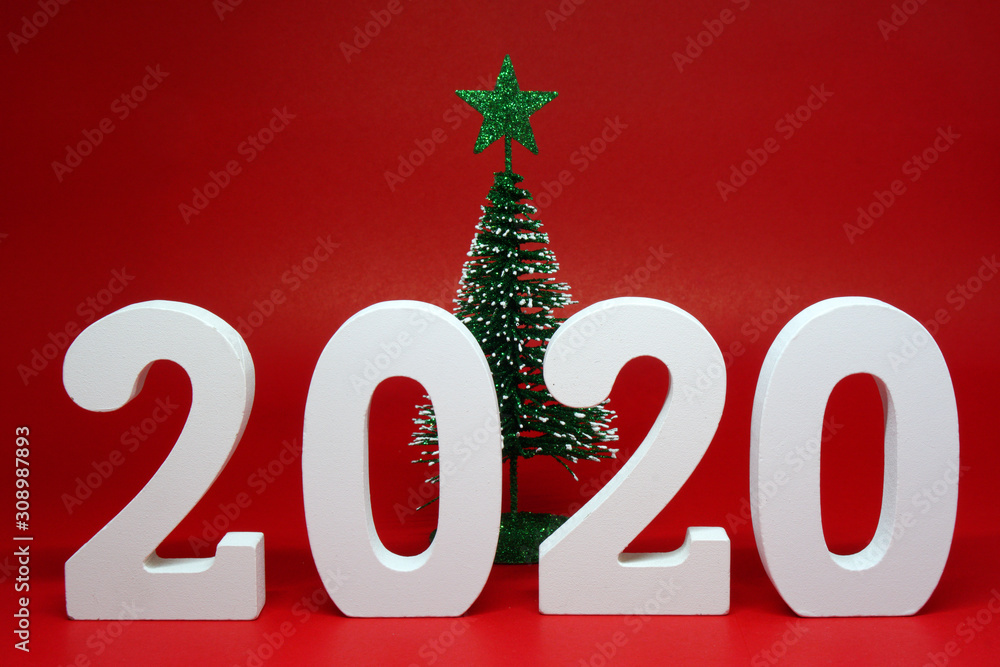 2020 number wooden figures with xmas tree or christmas tree object on red background - Happy new year 2020 , xmas celebration - red concept 