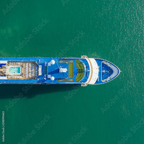 Aerial top view Modern transportation with Large cruise ship in sea. Top view from drone of beautiful large blue ship at across the Gulf of Thailand  © AU USAnakul+
