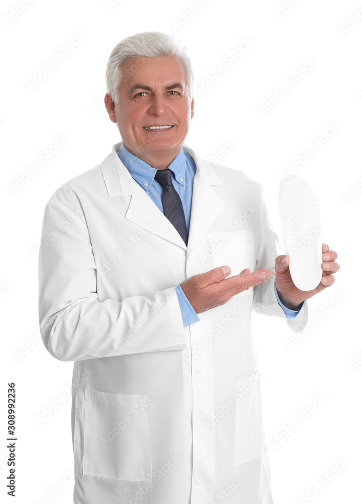 Male orthopedist showing insole on white background