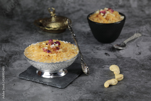 Seviyan or Vermicelli kheer, an Indian dessert made of semolina noodles topped with rose petals and dry fruits such as Cashews photo