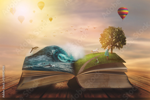 Concept of an open magic book; open pages with water and land and small child. Fantasy, nature or learning concept, with copy space © hiddencatch