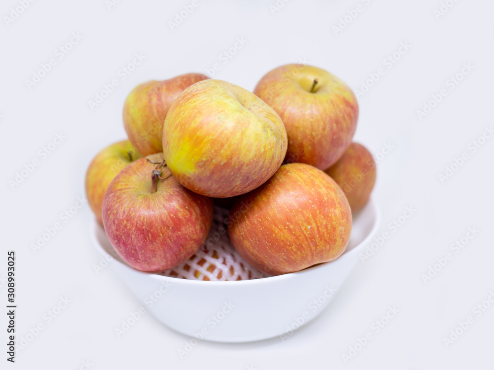 red Apple Honey Core in a bowl on white background red Apple Honey Core in a bowl on white background