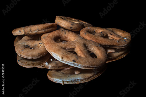 Homemade whole grain snacks with reflection on shiny black background