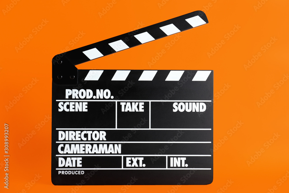Fototapeta premium Clapper board on orange background. Cinema production