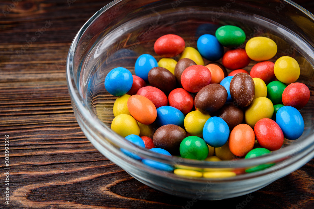 Color dragee on dark wooden background. Color dragee on dark wooden background.