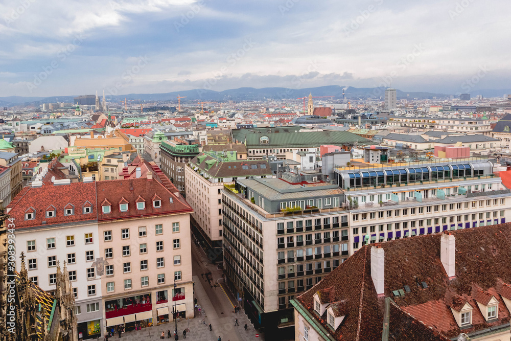 View of city, roofs of houses and skyline mountains Alps from St. Stephen's Cathedral, Vienna, Austria