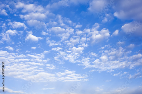 Beautiful background of white light clouds on a blue sky on a clear day