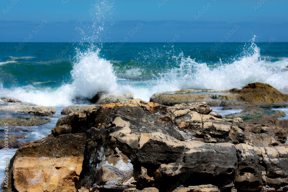 Waves hitting rocks at a shore