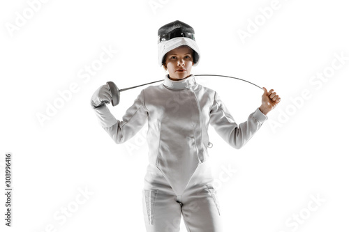 Teen girl in fencing costume with sword in hand isolated on white studio background. Young female caucasian model practicing and training in motion, action. Copyspace. Sport, youth, healthy lifestyle.