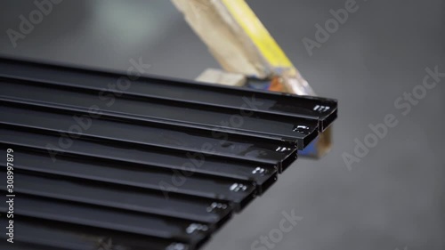 Coloured Aluminum profiles after anodizing process in the factory. Electrolytic passivation process to increase the thickness of natural oxide layer on the surface of metal parts. photo