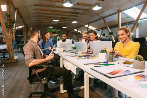 Young designers working with project, discussing new order development