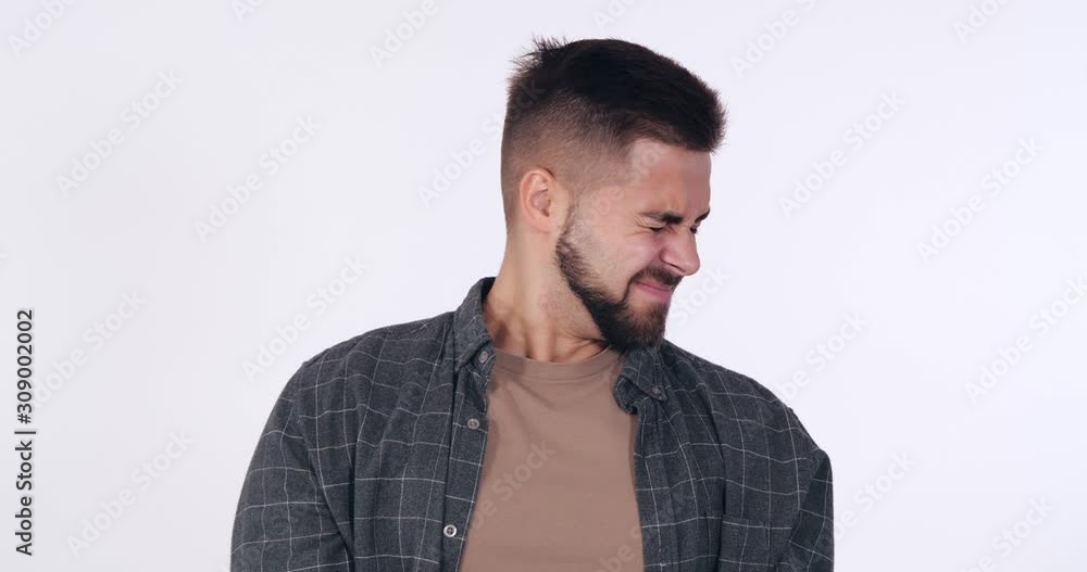 Handsome young man feeling disgusted on white background Handsome young man feeling disgusted on white background