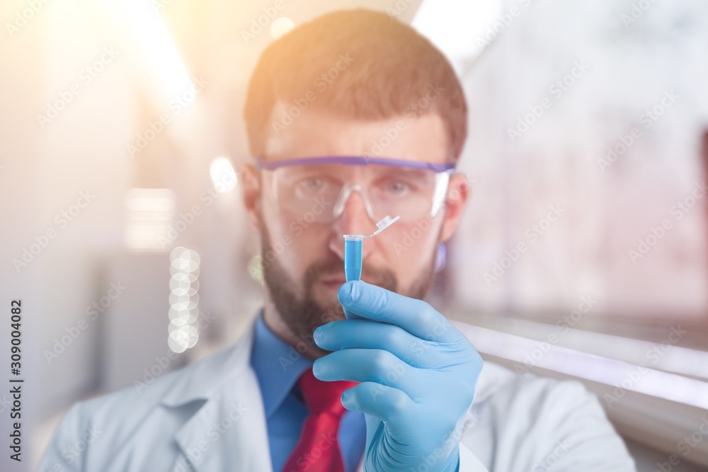 Hand holding syringe and vaccine. Hand holding syringe and vaccine.