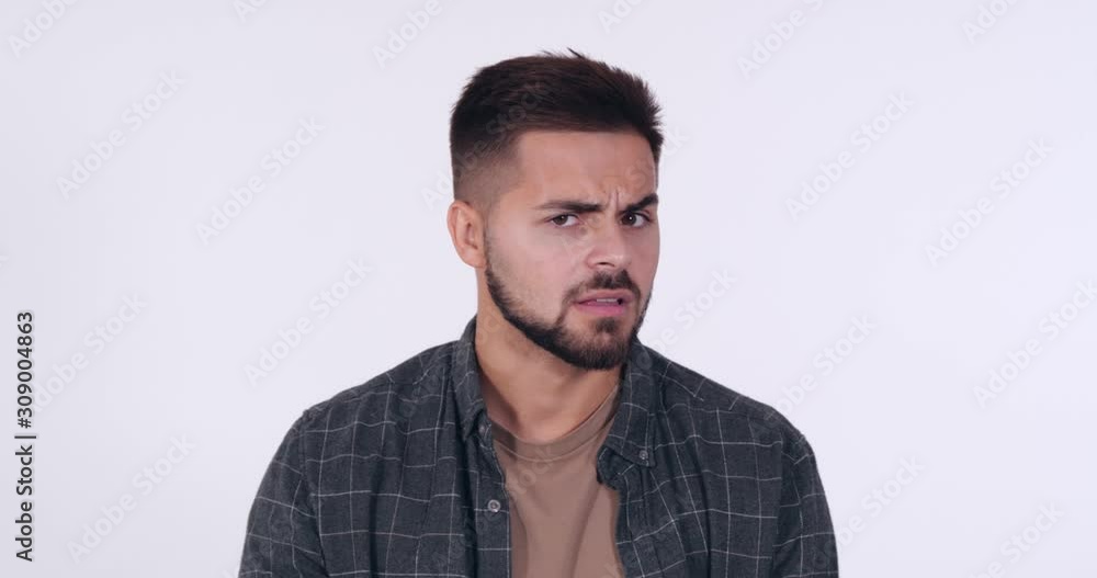 Dissatisfied handsome young man on white background Dissatisfied handsome young man on white background