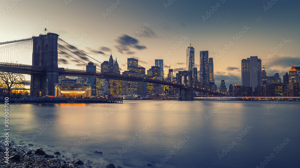 Brooklyn bridge East river and Manhattan after sunset, New York City