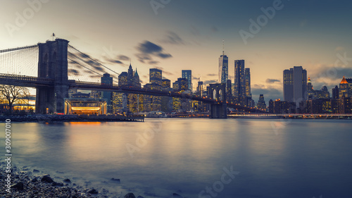 Brooklyn bridge East river and Manhattan after sunset, New York City © sborisov
