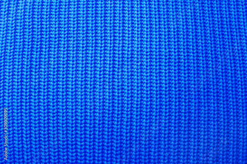 Blue knitted sweater background wallpaper. Monochrome trendy color of the year 2020