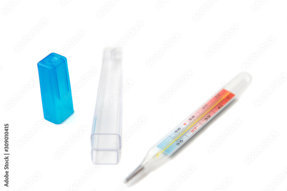 The medical mercury thermometer and it`s plastic case isolated over white background. Medical care. Selective focus. Side view The medical mercury thermometer and it`s plastic case isolated over white background. Medical care. Selective focus. Side view