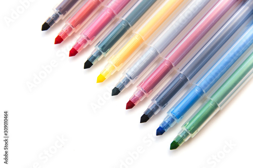 Colorful markers scattered on a white background. Art and education. Isolated. Side view Selective focus.