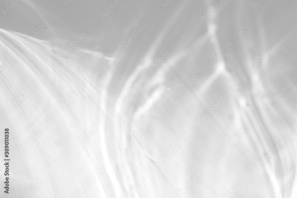 Water texture overlay effect for photo and mockups. Organic drop diagonal shadow and light caustic effect on a white wall. Water texture overlay effect for photo and mockups. Organic drop diagonal shadow and light caustic effect on a white wall.