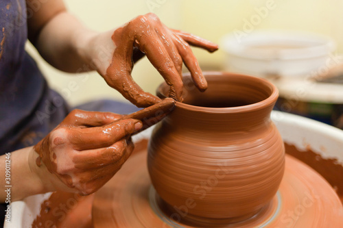 Potter gives final shape to clay product