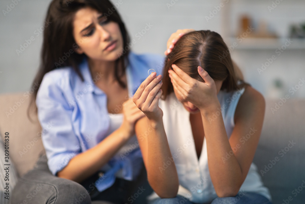 Friend Comforting Girl After Breakup With Ex-Husband Sitting On Couch Friend Comforting Girl After Breakup With Ex-Husband Sitting On Couch