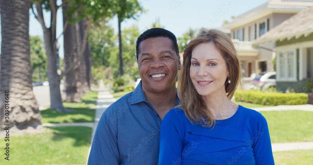 Portrait of senior couple smiling on sidewalk in suburban neighborhood Portrait of senior couple smiling on sidewalk in suburban neighborhood