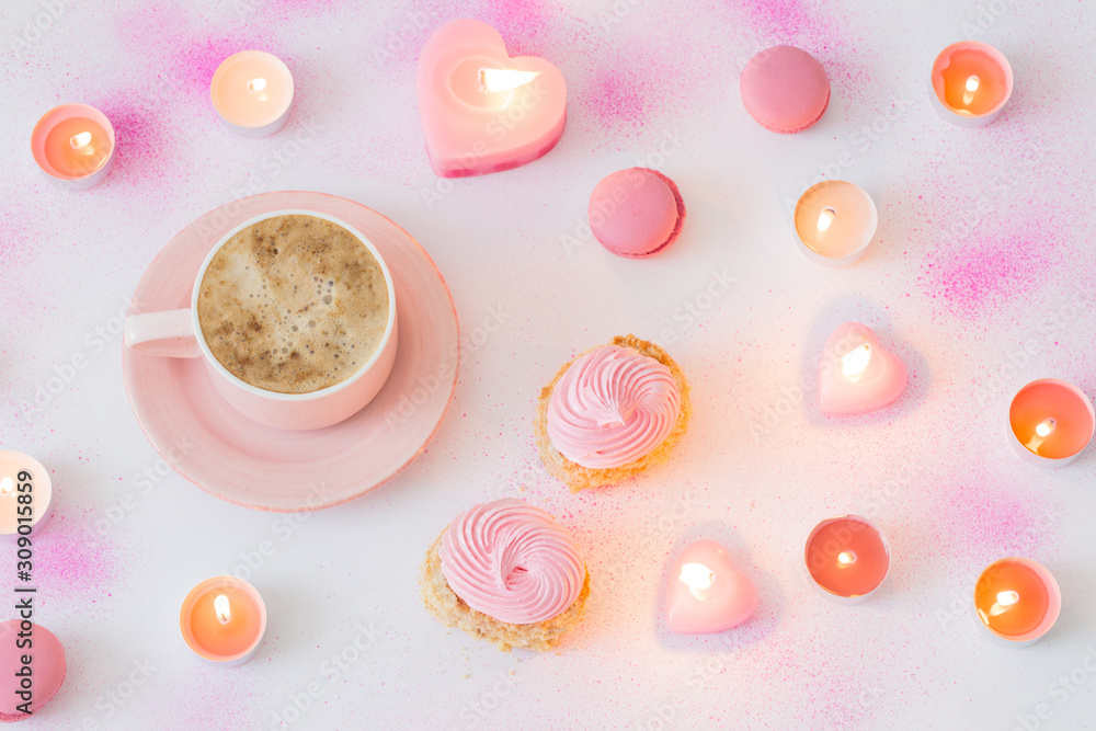 cup of coffee with burning candles on pink painted paper background cup of coffee with burning candles on pink painted paper background