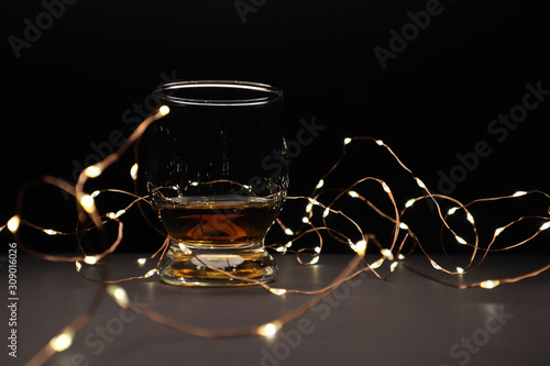  whiskey and yellow lanterns on dark background. Christmas  mood
