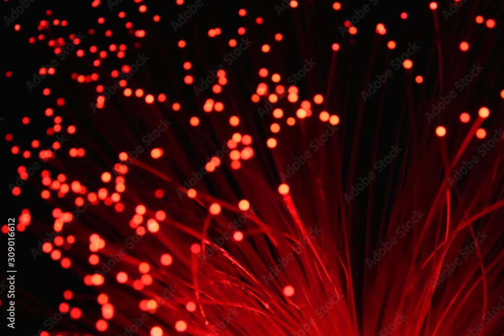 New Year and Christmas color illumination. The illusion of a salute explosion. The quirks of light fiber optic lamp. Blurry circles, bokeh on a dark background. Big explosion. New Year and Christmas color illumination. The illusion of a salute explosion. The quirks of light fiber optic lamp. Blurry circles, bokeh on a dark background. Big explosion.