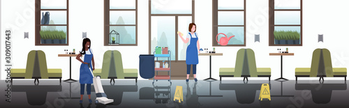 couple cleaners using rag and vacuum cleaner mix race female janitors in uniform cleaning service concept modern cafe interior horizontal full length sketch vector illustration