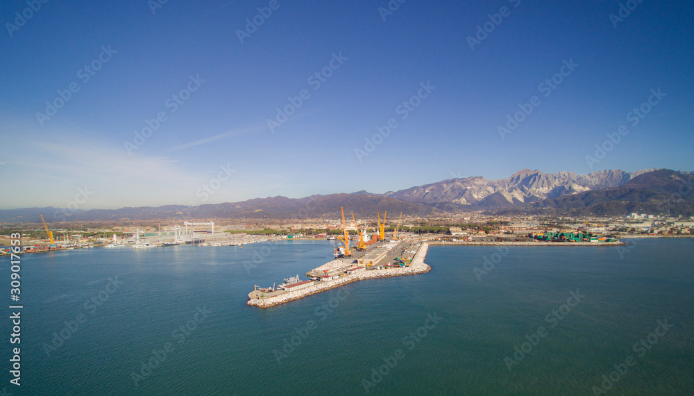 Italy, Tuscany: aerial view of the port in Marina di Carrara and in the background the Apuan Alps with the marble quarries