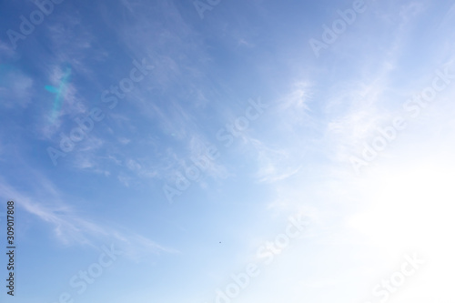 Beautiful blue clear sky with white clouds background in sunny day and copy space. Nature bright sky background image. Summer blue sky with sunlight. Texture for Design. Natural cloudy Wallpaper.