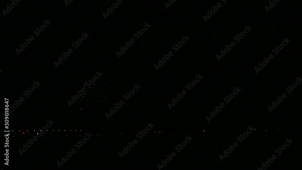 Bright festive fireworks in the night sky over the river with reflection in the water Bright festive fireworks in the night sky over the river with reflection in the water
