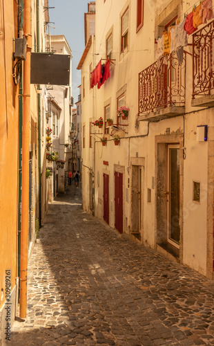 Narrow residential alley in the Alfama district in summertime, Lisbon City Centre.