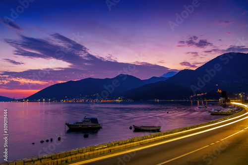 Sunset view of Kotor bay and coastal road near Tivat, Montenegro.