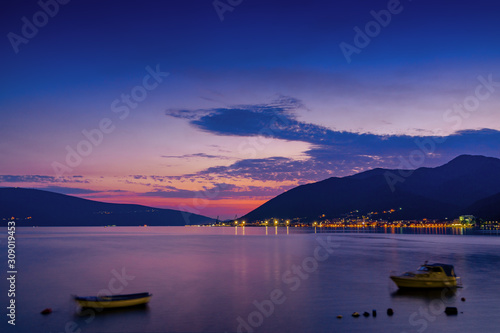 Sunset view of Kotor bay and coastal road near Tivat, Montenegro.