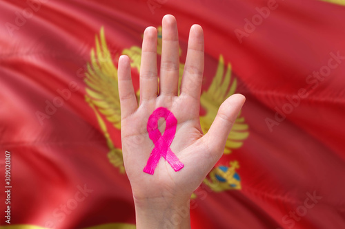 Wallpaper Mural Montenegro awareness concept. Close-up awareness ribbon painted on palm on national flag background. October Pink day and world cancer day. Torontodigital.ca
