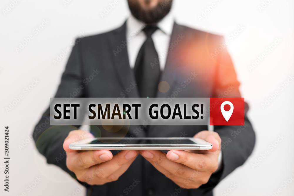Handwriting text writing Set Smart Goals. Conceptual photo list to clarify your ideas focus efforts use time wisely Male human wear formal work suit hold smart hi tech smartphone use hands Handwriting text writing Set Smart Goals. Conceptual photo list to clarify your ideas focus efforts use time wisely Male human wear formal work suit hold smart hi tech smartphone use hands