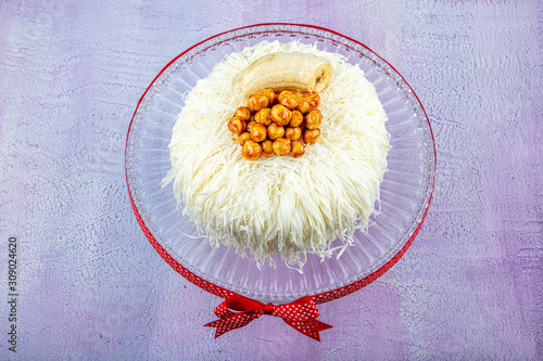 Banana cake (sacakli yas pasta) with white chocolate. on pink wooden background. pastry shop concept. photo