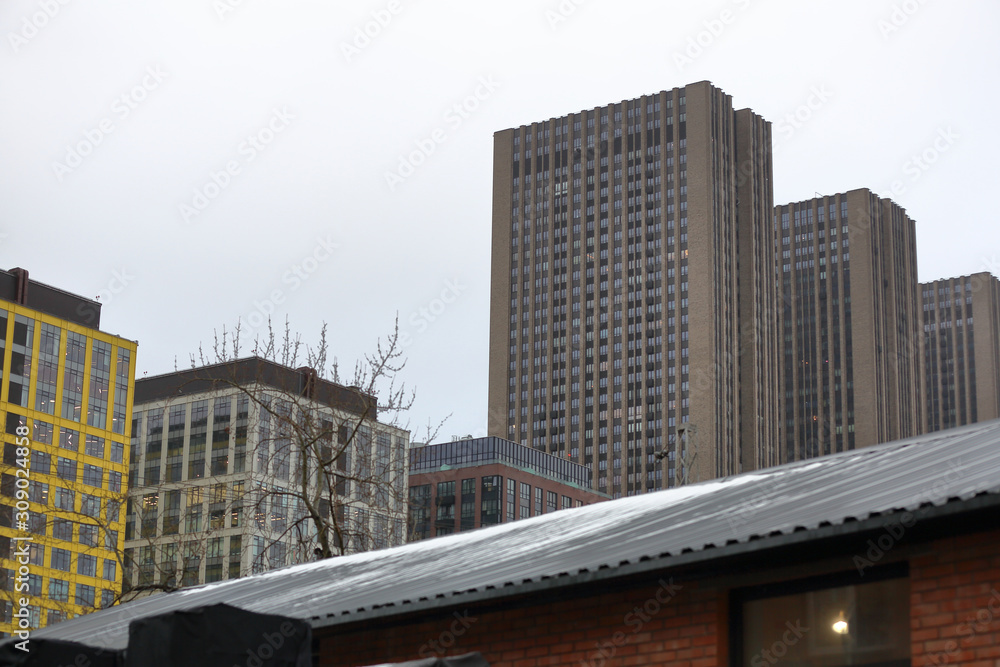 High-rise building with offices in an industrial area on a cloudy day High-rise building with offices in an industrial area on a cloudy day