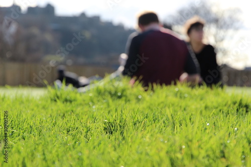 blurred man and woman sitting and talking in a park © Serge