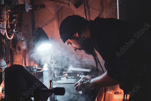 In the busy workshop a talanted master is working on his new project. photo