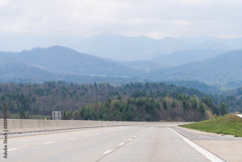 Smoky Mountains near Asheville, North Carolina near Tennessee border with cloudy sky and forest trees on steep i26 highway road