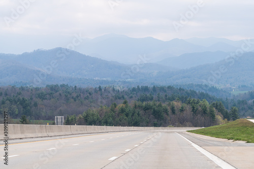 Smoky Mountains near Asheville, North Carolina near Tennessee border with cloudy sky and forest trees on steep i26 highway road © Andriy Blokhin