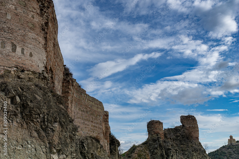 The ruins of the Narikala fortress on a background of blue transparent sky. Tbilisi. Georgia.