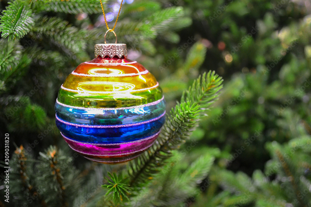 Close up of a bright glass rainbow colored Christmas ball bauble