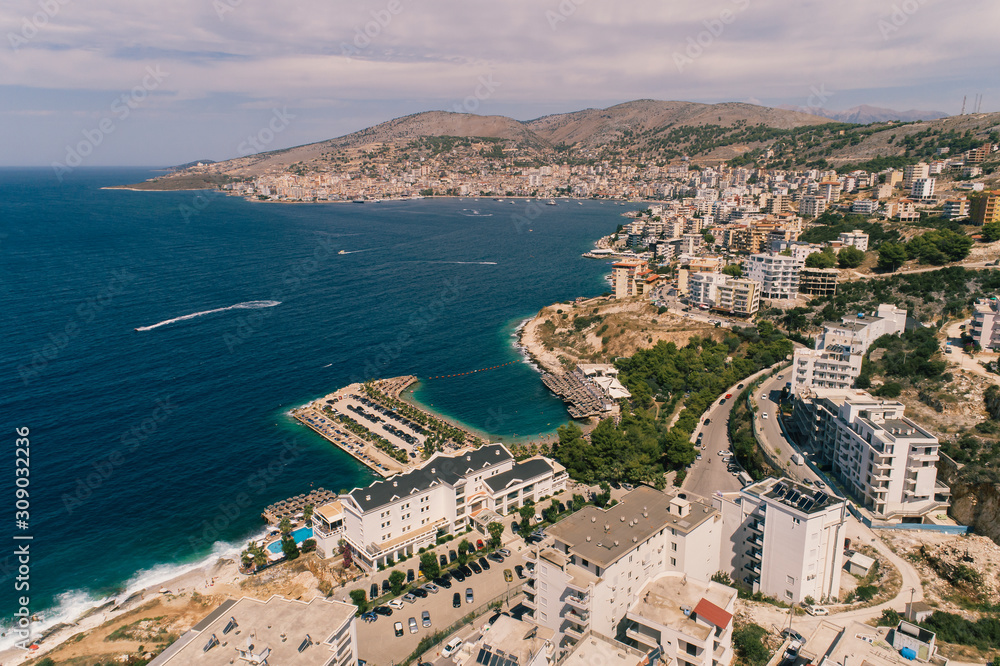 Aerial view - Sarande, The Capital of Albanian Riviera - drone shot - up point of view. The Mediteranean Sea and the city center in the background