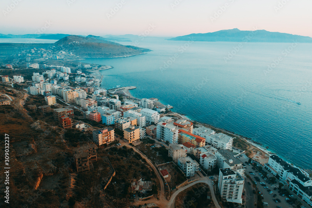 Aerial view - Sarande, The Capital of Albanian Riviera - drone shot - up point of view. The Mediteranean Sea and The Corfu Island in the forground.