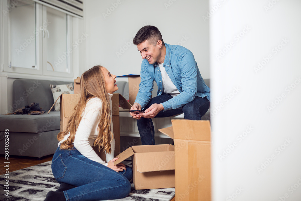 Happy couple moving in new home Happy couple moving in new home